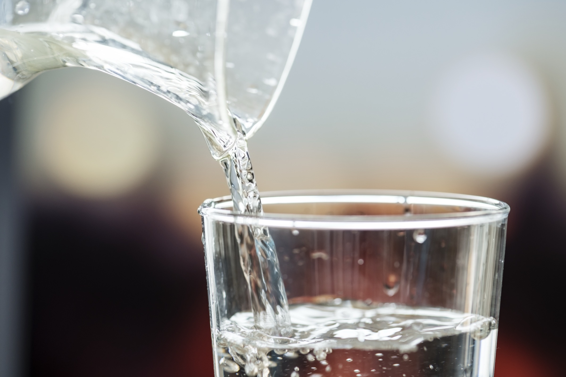Clear water being poured into a glass